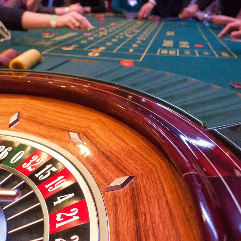 Professional dealer running a stylish roulette game with golden highlights — the refined 8JJBET atmosphere.