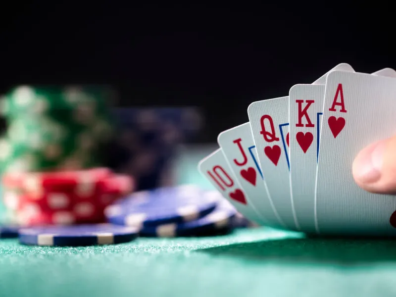 Luxurious gaming suite featuring an elegant guest at the roulette table — signature 8JJBET visual identity.